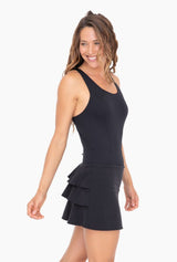 Black ruffle bottom tennis dress with built in shorts cross cross back detail and tiered ruffle back detail discreet back zipper.